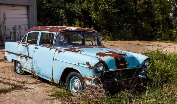 Blue tarps and rusting cars can be a part of the rural landscape